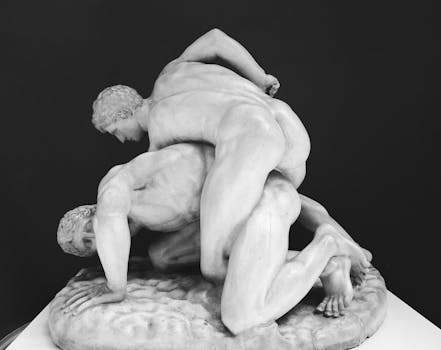 Historic marble sculpture depicting an intense wrestling scene from ancient Greece.